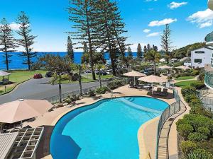 an overhead view of a swimming pool at a resort at Bergmann 3 bdrm Suite on Moffat Beach with Onsite Parking in Caloundra