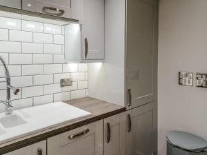 a white kitchen with a sink and a toilet at The Hive in Newcastle upon Tyne