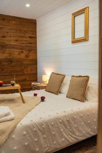 a bedroom with a bed with two pillows on it at Ô Temps Des Pins in Éguilles +16 photos