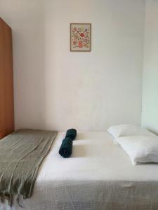 a bed with a teddy bear sitting on top of it at Studio Brasilia in Mont-de-Marsan