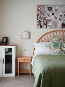 a bedroom with a bed and a table with a night stand at Bed and Breakfast Quercia di Croara in Parrochia di Croara