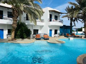 a swimming pool in front of a hotel at New Sphinx Resort in Dahab