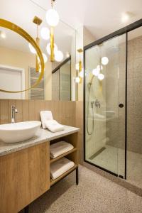 a bathroom with a sink and a shower at Fragola Apartments Vistula View in Kraków +28 photos