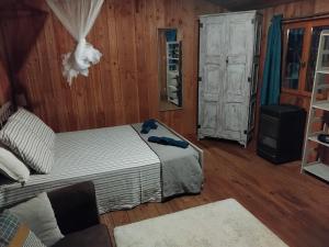a bedroom with a bed in a room with wooden walls at Chalet Banassac in Saint-Ambroix