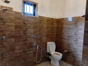 a bathroom with a toilet and a window at Mivin Villa - Madiha in Godakanda +18 photos