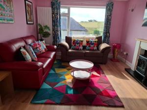 un soggiorno con un divano e un tavolo di Cosy little house on Great Orme a Llandudno