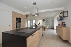 a kitchen with a black counter top and a table at La rosalie in Visseiche