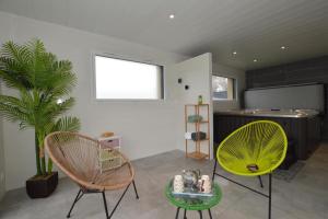 a living room with two chairs and a table at La rosalie in Visseiche