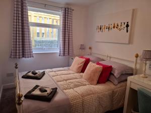 una camera da letto con un letto con due asciugamani sopra di Cosy little house on Great Orme a Llandudno