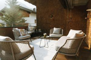 レッヒにあるMargarethe Apartments Lechのパティオ(籐の椅子、テーブル付)