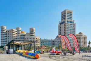 a beach with tall buildings in the background at Private Suites Al Hamra Palace at golf & sea resort in Ras al Khaimah