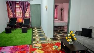 a living room with a couch and a green rug at Homestay Kuala Lumpur in Kuala Lumpur