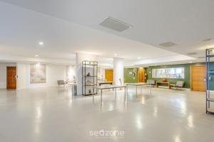 a large room with tables and chairs in it at Apto em Cond. c/ Piscina aquecida CUR0905 in Florianópolis +22 photos