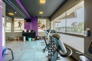 a gym with a row of treadmills at Apto em Cond. c/ Piscina aquecida CUR0905 in Florianópolis