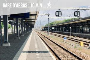 a train station with a platform and train tracks at L'Escapade Secrète balnéo - sauna - love room in Arras