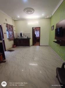 a large room with a large tile floor and green walls at AAK Hills stay villa in Kodaikānāl +32 photos