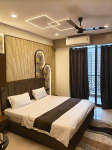 a bedroom with a large bed with a ceiling fan at CozyCity Retreat 2 Studio Apartment with Kitchen Perfect for longer stays in Lucknow