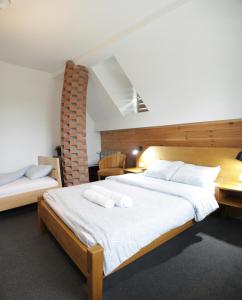 a bedroom with a large bed with two towels on it at Gorski vrt in Novi Sad