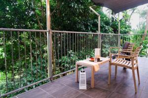 a patio with a table and a chair and a lamp at The Point in Innisfail