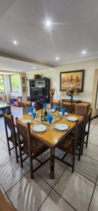 a dining room with a wooden table and chairs at Thiseldoo Holiday Home in Scottburgh