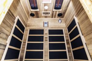 an overhead view of the inside of a building with wooden doors at Devon Hot Tub Retreat in Bideford