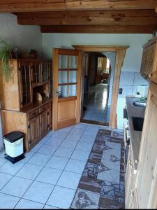 a kitchen with an open door and a tile floor at Ferienhaus Piller in Viechtach