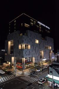 a large building with a parking lot in front of it at J Square Hotel and Wedding in Jinju
