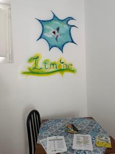 a dining room table with a star on the wall at Tentazioni Rooms in Tramonti