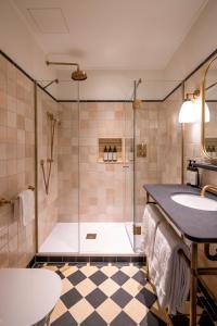 a bathroom with a shower and a sink at Miiro Palais Rudolf NEW OPENING in Vienna
