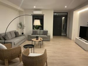 a living room with a couch and chairs and a tv at Esmeralda Sea Villa - Beach&Golf Sancti Petri in Novo Sancti Petri