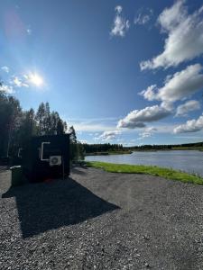 a dumpster on the shore of a lake at Aurora Forest Cabin in Rovaniemi