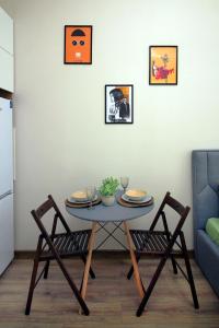 a table and chairs in a living room at Leon, location Metro, Arbat in Almaty +4 photos