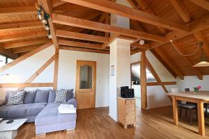a living room with a couch and a table at Gästehaus Huber in Immenstaad am Bodensee