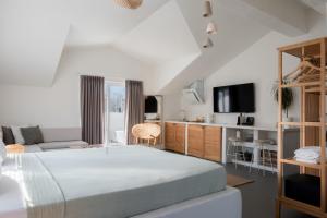 a bedroom with a large bed and a tv at L'olive homes in Marmaris