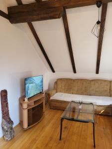 a living room with a couch and a tv at N&M Mountain Escape in Kupres