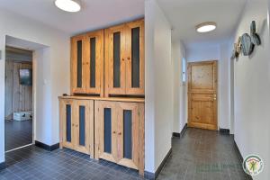 a room with wooden cabinets and a hallway at La maison bleue in Trégastel +62 photos