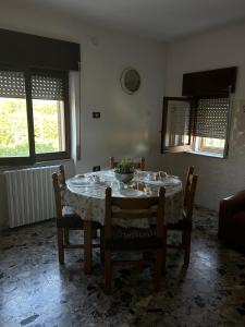 a dining room table with chairs and a bowl on it at B&B Da Vincenzo e Teresa in Bella +24 photos
