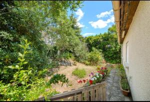 a view of a garden with flowers on a balcony at Cosy house in Saint-Aunès