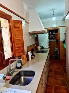 a kitchen with a sink and a counter top at Torreon de Nubla in Cazorla