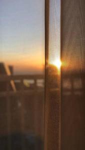 a sunset seen through a window of an airplane at Seaside Manila Bay Sunset View at SM Mall of Asia in Manila