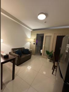 a living room with a couch and a table at Seaside Manila Bay Sunset View at SM Mall of Asia in Manila