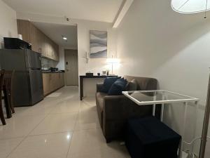 a living room with a couch and a kitchen at Seaside Manila Bay Sunset View at SM Mall of Asia in Manila