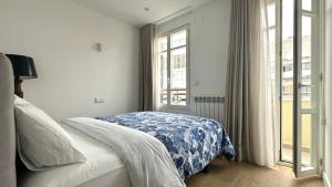 a bedroom with a bed and a large window at CoruñaFlat Apartamentos con encanto en el centro de A Coruña in A Coruña