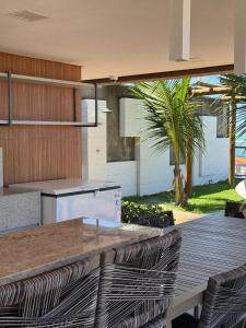 a kitchen with a wooden deck with a table and chairs at Flat na BeiraMar com Piscina Privativa in Porto De Galinhas