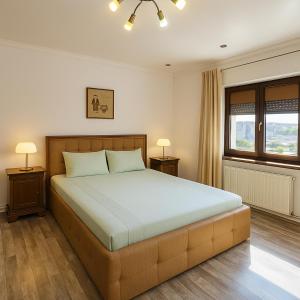 Ένα ή περισσότερα κρεβάτια σε δωμάτιο στο Grand Apartments