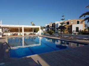 a swimming pool with blue water in a resort at Archipelagos in Naxos Chora