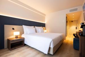 a large white bed in a hotel room at The Lince Braga in Braga +57 photos