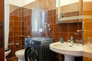 a bathroom with a washing machine and a sink at Dimora Aurelia Rome & Sea in La Massimina-Casal Lumbroso +47 photos