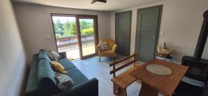 a living room with a couch and a table at dziupla in Górki Wielkie