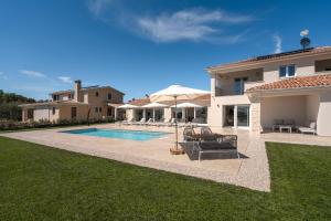 a villa with a swimming pool and a house at Villa Juki by Briskva in Kaštel